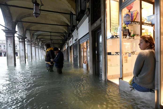 Venice Tidal Surge A woman looks on from a shop at the flooded St. Mark’s Square in Venice, Italy on Nov. 15. REUTERS/FLAVIO LO SCALZO