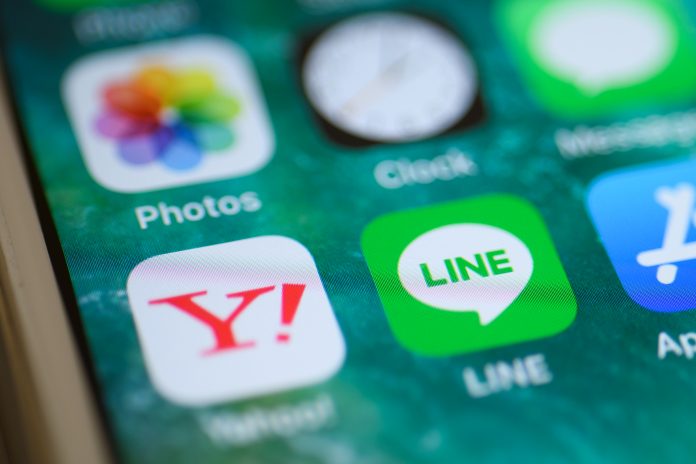 The icons for the Yahoo Japan and Line applications are displayed on a smartphone. GETTY IMAGES