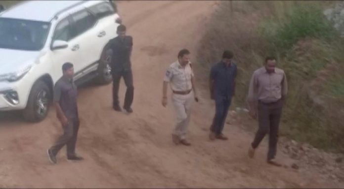 Still frame taken from Dec. 6 video shows Cyberabad Police Commissioner V.C. Sajjanar and other police officers arriving at a spot where police shot dead four men suspected of raping a veterinary doctor, in Hyderabad, Telangana, India. ANI/VIA REUTERS TV