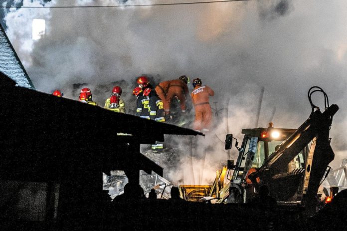 Firefighters work at the site of a building leveled by a gas explosion in Szczyrk, Poland on Dec. 4. AGENCJA GAZETA/GRZEGORZ CELEJEWSKI/VIA REUTERS
