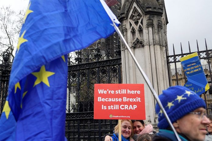 Anti-Brexit demonstrators Anti-Brexit demonstrators hold signs outside the Houses of Parliament in London, Britain, Dec. 17, 2019. REUTERS