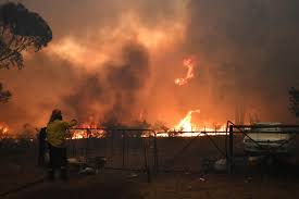 Australian state declares emergency Rural Fire Service crews engage in property protection of a number of homes along the Old Hume Highway near the town of Tahmoor as the Green Wattle Creek Fire threatens a number of communities in the southwest of Sydney, Australia on Dec. 19. AAP IMAGE/DEAN LEWINS/VIA REUTERS