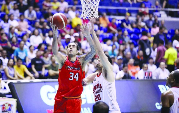 NorthPort Batang Pier’s Christian Standhardinger scores against Barangay Ginebra San Miguel Kings’ Gregory Slaughter. PBA PHOTO