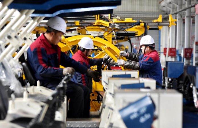 Employees Employees work on a drilling machine production line at a factory in Zhangjiakou, Hebei province, China. Manufacturers in the United States expect a bounce in revenues in 2020 despite lingering unease over trade tariffs that are prompting supply chain shifts, according to an industry survey released Monday. REUTERS