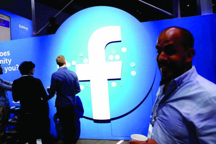 Facebook Attendees walk past a Facebook logo during Facebook Inc.’s F8 developers conference in San Jose, California, United States. Australia said on Thursday technology giants such as Facebook Inc. and Google will have to agree to new rules to ensure they do not abuse their market power and damage competition, or the government will impose new controls on them. REUTERS