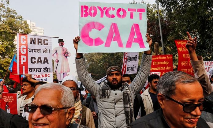 Demonstrators hold placards during a protest against a new citizenship law, in New Delhi Protesters march against a new citizenship law in New Delhi, India on Dec. 24. REUTERS