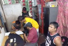 Antidrug operatives inspect items seized from “high-value” suspect Junel Salazar during an entrapment operation in Barangay 6, Bacolod City on Dec. 28. POLICE STATION 3/BCPO