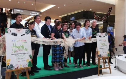Deputy speaker Loren Legarda (5th from left), Gov. Rhodora Cadiao (3rd from right) and officials of the Department of Tourism-Antique lead the ribbon-cutting ceremony of the Philippine Harvest at the Central Square in Taguig City on Nov. 29. PNA/JOYCE ROCAMORA