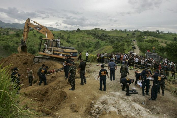 Maguindanao Massacre Relatives wait as police recover dead bodies along a hillside grave in Ampatuan town, Maguindanao on Nov. 24, 2009. AARON FAVILA/AP/FILE