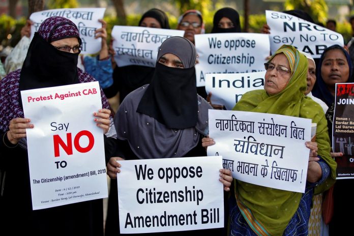 Demonstrators display placards during a protest against the Citizenship Amendment Bill, which seeks to give citizenship to religious minorities persecuted in neighboring Muslim countries, in Ahmedabad, India on Dec. 9. REUTERS/AMIT DAVE