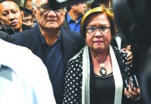 Security personnel escort Sen. Leila de Lima to a press conference. One of the fiercest critics of President Rodrigo Duterte, De Lima is accused of having abetted the illegal drug trade in the New Bilibid Prison when she was justice secretary from 2010 to 2015. GETTY IMAGES