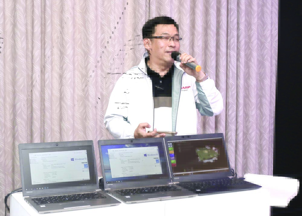 New Business Development Department senior manager Peter Villanueva demonstrates Dynabook Laptop, a laptop designed for business professionals and workplace environments.