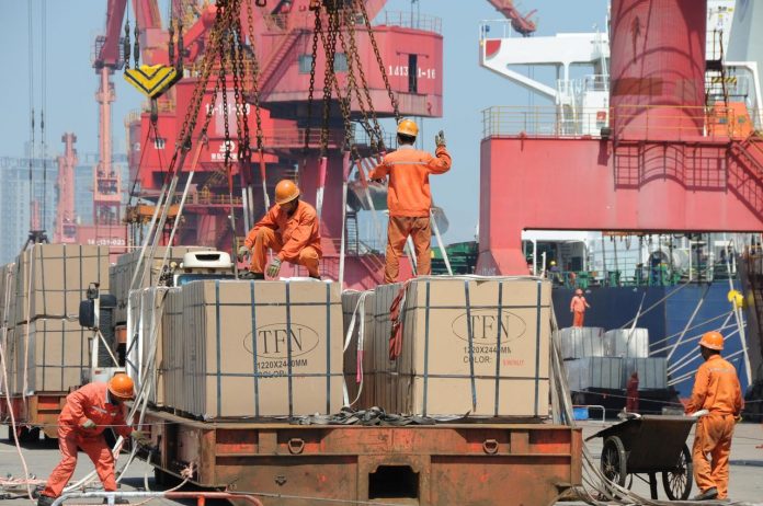 Workers load goods for export onto a crane at a port in Lianyungang, Jiangsu province, China June 7, 2019. China’s trade with the United States sank in November as negotiators of the two giant economies worked on the first stage of a possible deal to end the tariff war. REUTERS