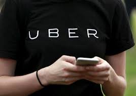 An Uber representative registers people on his smartphone in the Queens borough of New York. REUTERS