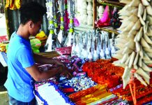A firecracker vendor in Tigbauan, Iloilo attends to his goods. Firecrackers can only be sold in designated zones set by the local government unit in coordination with the Philippine National Police and the Bureau of Fire Protection. Panay News