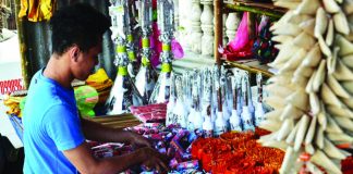 A firecracker vendor in Tigbauan, Iloilo attends to his goods. Firecrackers can only be sold in designated zones set by the local government unit in coordination with the Philippine National Police and the Bureau of Fire Protection. Panay News