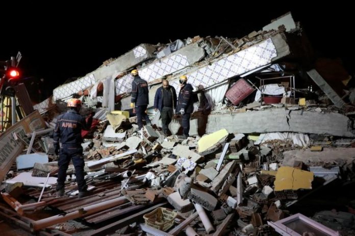 Rescue workers search on a collapsed building after an earthquake in Elazig, Turkey on Jan. 25. REUTERS/SERTAC KAYAR