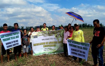 The seven farmers installed by personnel of the Department of Agrarian Reform Negros Occidental-South on the 11.1 hectares of landholding in Barangay Payao, Binalbagan town on Jan. 15. DAR NEGROS OCCIDENTAL-SOUTH