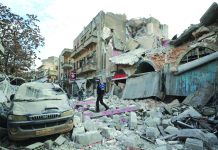 U.N. Rights boss: Syria Ceasefire failed as civilians killed daily Syrian walks on the rubble of a building following an airstrike in Idlib on Jan. 15,2020. AFP
