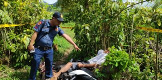 A police officer points at Alejandro Panganiban who was found lifeless with a gunshot wound on the body in Barangay Caliban, Murcia, Negros Occidental on Jan. 2. CCTO