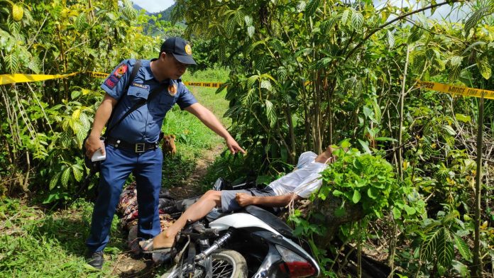 Alejandro Panganiban A police officer points at Alejandro Panganiban who was found lifeless with a gunshot wound on the body in Barangay Caliban, Murcia, Negros Occidental on Jan. 2. CCTO