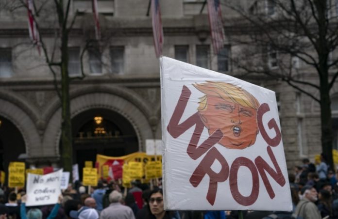 Anti-war demonstrators march past the Trump International Hotel during a demonstration against war in Iraq and Iran in Washington DC on Jan. 4, 2020. AFP