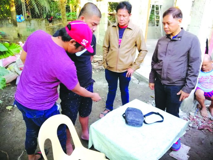 Barangay Banago, Bacolod City Antidrug operatives frisk one of the suspects nabbed in a drug buy-bust operation in Barangay Banago, Bacolod City on Jan. 21. CDEU/BCPO