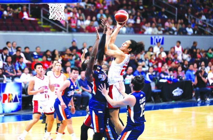 Barangay Ginebra San Miguel Kings' Japeth Aguilar attacks the defense of Meralco Bolts' Allen Durham for an inside hit. PBA PHOTO