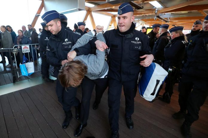 A demonstrator is carried away by police officers during a protest of the climate action group Extinction Rebellion at a motor show in Brussels, Belgium on Jan. 18. REUTERS/YVES HERMAN