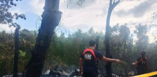 Officers of the Bureau of Fire Protection check the remains of houses destroyed after fire hit Barangay Cagbang, Oton, Iloilo on Jan. 3. IAN PAUL CORDERO/PN