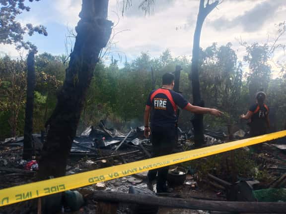 Officers of the Bureau of Fire Protection check the remains of houses destroyed after fire hit Barangay Cagbang, Oton, Iloilo on Jan. 3. IAN PAUL CORDERO/PN