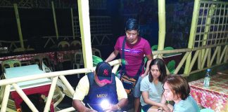 An antidrug officer inspects items seized from Angielyn Marba and Andrew Delasan. Marba and Delasan were nabbed in an entrapment operation in Barangay Punta Taytay, Bacolod City. POLICE STATION 9/ BCPO