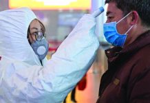 Germany confirms first case of coronavirus A medical worker checks a passenger’s temperature at Nanjing South Railway station on Monday, Jan. 27. EPA-EFE