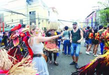 Foreign visitors join the merry-making with the energized warriors of various ati-ati tribes during the first-ever “Dagyang sa Calle Real” on the stretch of Iloilo City’s Calle Real (JM Basa Street) on Saturday. IAN PAUL CORDERO/PN