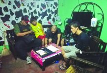 Antidrug officers inspect items confiscated from Hernan De Asis in a buy-bust operation in Barangay 27 on Monday. POLICE STATION 4/ BCPO