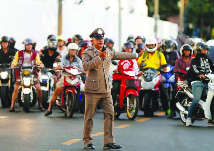 King Maha Vajiralongkorn A Thai traffic police officer stops vehicles as King Maha Vajiralongkorn’s convoy passes near the Grand Palace, ahead of the King’s coronation, in Bangkok, Thailand on May 2, 2019. REUTERS/SOE ZEYA TUN/FILE PHOTO