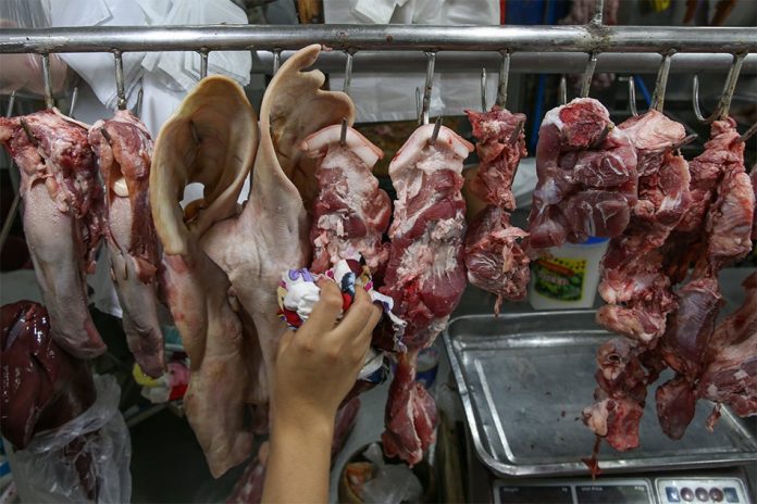 Meat is arranged at a public market stall in Antipolo City. A Philippine National Bank research warns Taal eruption could disrupt chicken and pork supply. ABS-CBN NEWS