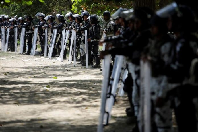 Mexico halts migrant caravan Mexican security forces guard the riverside in Ciudad Hidalgo, Mexico on Jan. 21. REUTERS/ANDRES MARTINEZ CASARES
