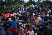 Migrants gather on Guatemala border to enter Mexico en masse Migrants from Central America, part of a caravan travelling to the United States, wait to cross into Mexico in El Ceibo, Guatemala on Jan. 18. REUTERS/VICTOR PENA