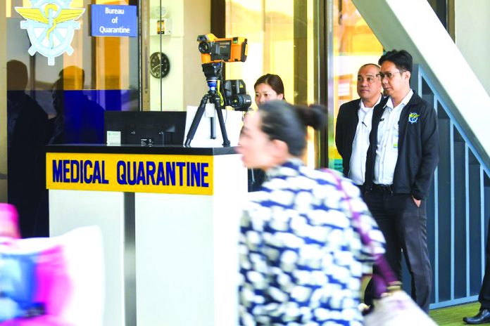 New coronavirus in PH Passengers at the Ninoy Aquino International Airport Terminal 1 pass in front of a thermal imaging machine used to look for possible signs of illness on January 23, 2020, as the country raises the alert to prevent the spread of the new coronavirus originating from Wuhan, China. ABS-CBN NEWS