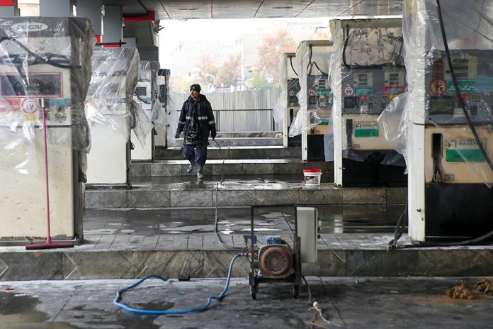 Oil A man walks near the remains of gas pump stands, during protests against increased fuel prices, in Tehran, Iran. REUTERS