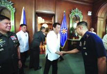 President Rodrigo Duterte (center) greets security officials at the Malacañang Palace on Monday. Duterte has ordered the military to prepare to deploy its aircraft and ships "at any moment's notice" to evacuate thousands of Filipino workers in Iraq and Iran should hostilities erupt there. PCOO