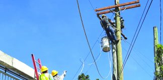 Linemen of Task Force Kapatid Ursula fix electric poles to restore electricity in the affected areas of Aklan and Antique. AKELCO PHOTO