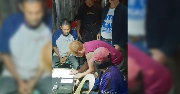 Reynaldo Cientos Antidrug officers inspect the items seized from drug suspect Reynaldo Cientos during an entrapment operation in Barangay 29, Bacolod City on Jan. 5. POLICE STATION 1/BCPO