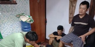 An antidrug officer inspects the items seized from drug suspects Rish Ivan Javier and Ryan Libre during an entrapment operation in Barangay 1, Bacolod City on Jan. 29. POLICE STATION 2/BCPO