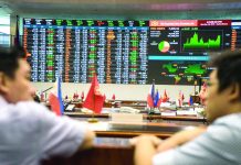 Within-expectation January inflation backs PSEi, peso Traders talk in front of an electronic board displaying stock figures and currency exchange rates on the floor of the Philippine Stock Exchange in the Makati district of Manila, the Philippines. BLOOMBERG