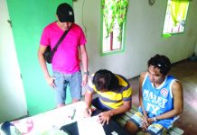 Antidrug officers inspect items seized from Roger Dela Cruz. Dela Cruz was nabbed in an entrapment operation in Barangay Alijis, Bacolod City. POLICE STATION 8/ BCPO