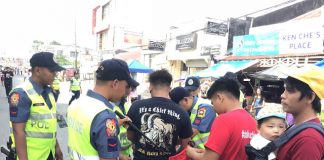 Police officers inspect the belongings of merrymakers. Kalibo chief of police Lieutenant Colonel Richard Mepania said around 1,700 police officers were deployed to secure the Ati-Atihan Festival on Jan. 10 to 19. AKEAN FORUM