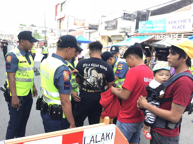 region Kalibo Police officers inspect the belongings of merrymakers. Kalibo chief of police Lieutenant Colonel Richard Mepania said around 1,700 police officers were deployed to secure the Ati-Atihan Festival on Jan. 10 to 19. AKEAN FORUM