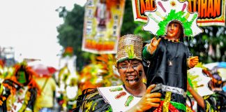 A performer holds an image of the Santo Niño. The Ati-Atihan Festival is among the religious celebrations in the Philippines which centers on the devotion to Child Jesus. IAN PAUL CORDERO/PN